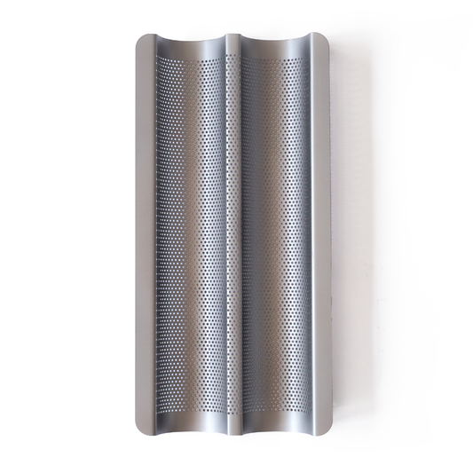 Non-stick perforated baguette tray for baking crisp baguettes